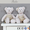 pink plush teddy bear toy with checked dress